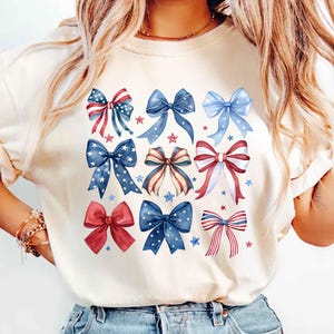 4th of july, america shirt, bow shirt, coquette america, coquette usa, election shirt, july 4, memorial day, patriotic shirt, red white and blue, usa bow shirt, usa shirt, usa tshirt