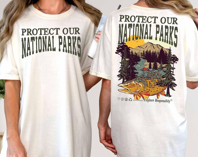 May include: White t-shirt with the text "Protect Our National Parks" printed on the front and a graphic of a fish, mountains, and trees with the text "Protect Our National Parks" and "Explore Responsibly" printed on the back.