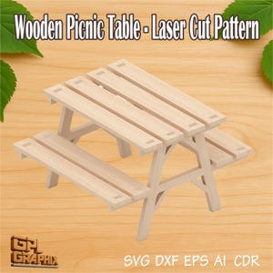 May include: A light-coloured wooden picnic table with attached benches. The table has a laser-cut pattern and is made of light-coloured wood. The text "Wooden Picnic Table - Laser Cut Pattern" is at the top of the image.