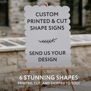 May include: A white, scalloped-edge sign on a wooden easel. The sign reads "CUSTOM PRINTED & CUT SHAPE SIGNS" and "SEND US YOUR DESIGN." Below, it says "6 STUNNING SHAPES PRINTED, CUT, AND SHIPPED TO YOU!"