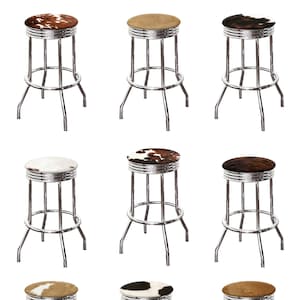 May include: Nine chrome bar stools with different cowhide seat cushions. The stools have a simple, classic design with a round seat and four legs.