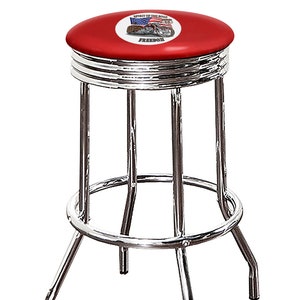 May include: A chrome-plated bar stool with a red vinyl seat. The seat features a circular graphic with an American flag, a motorcycle, and the words "SPIRIT OF THE ROAD" and "FREEDOM". The stool has a footrest and four legs.
