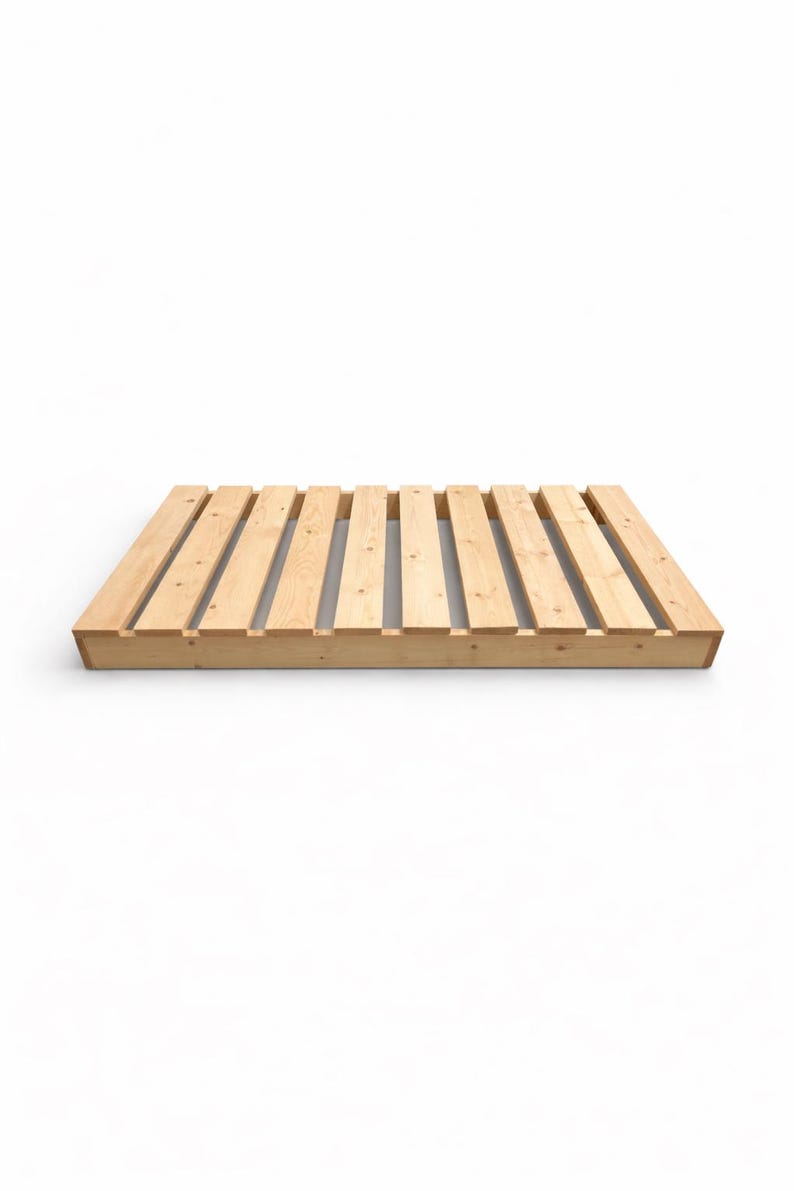 May include: A new, unfinished wooden pallet with a rectangular shape. The pallet is made of light-colored wood and features evenly spaced wooden slats. The design is simple and functional, suitable for various uses.