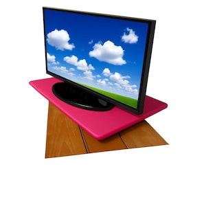 May include: A flat-screen television with a black frame displays a vibrant blue sky with fluffy white clouds. The TV sits on a bright pink rectangular surface, which is placed on a wooden, angled surface.