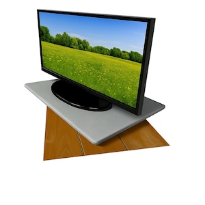 May include: A flat-screen television with a black frame displays a vibrant green field under a blue sky. The TV sits on a gray platform, which rests on a wooden surface. The image is set against a white background.