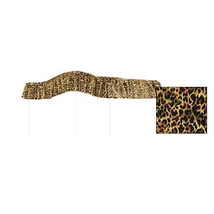May include: A brown and black leopard print fabric banner with a wavy shape. The banner is on white poles.