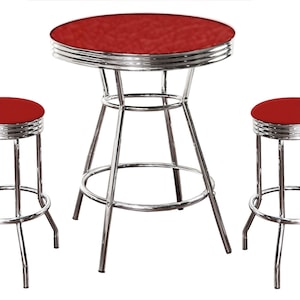May include: A red and chrome diner set with a round table and two stools. The table has a red vinyl top and chrome legs. The stools have red vinyl seats and chrome legs.
