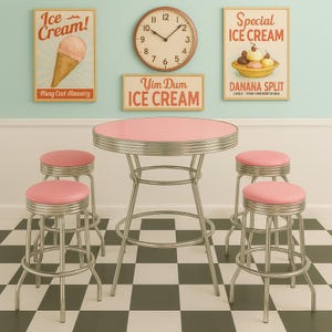 May include: A retro ice cream parlor set with a pink table and matching stools. The table has a chrome trim and a pink top. The stools have pink seats and chrome legs. Vintage ice cream posters and a clock are on the wall.