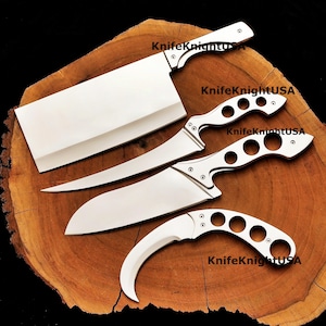 May include: A set of four stainless steel knives on a wooden surface. The set includes a cleaver, two curved blade knives, and a karambit knife. The text "KnifeKnightUSA" is visible on each knife.