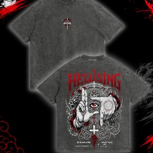 May include: Dark gray t-shirt with the word "HELLSING" in red, gothic lettering on the back. The design includes a hand forming a frame around an eye, a wolf, and other graphic elements. The front of the shirt has the word "HELLSING" in a smaller font.