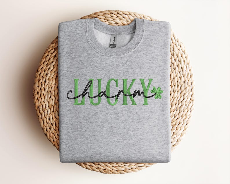 May include: A grey sweatshirt with the text "Lucky charm" in green letters and a green shamrock.