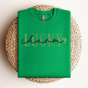May include: Green sweatshirt with the text "LUCKY charm" in gold embroidery and a green shamrock.