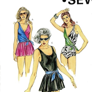 May include: A sewing pattern for three swimsuit styles. The pattern is called "KWIK-SEW" and the pattern number is 1428. The sizes included are 8, 10, 12, and 14. The pattern is for a grey swimsuit.