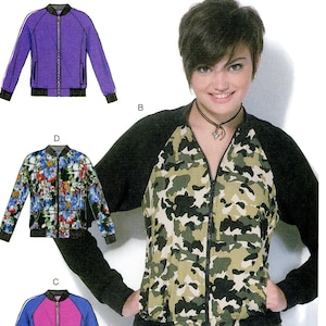 May include: McCall's M7100 sewing pattern. The image shows a woman wearing a camouflage bomber jacket. The pattern includes illustrations of different bomber jacket designs, including a purple, floral, and pink and blue jacket. The pattern size is Y (Xsm-Sml-Med).