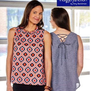 May include: Two women modeling sleeveless tank tops. The top on the left is a coral and black geometric print. The top on the right is a solid gray with a lace-up back detail. The text "Turn About Tank" is printed on the bottom of the image.