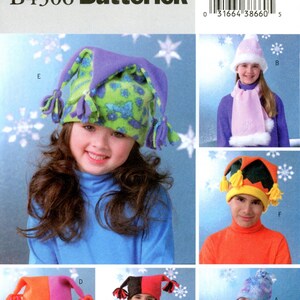May include: A sewing pattern for making five different styles of fleece hats. The hats are all in a jester style with a pointed top and a tassel. The hats are shown on five different children, each wearing a different hat and a matching scarf. The pattern is from Butterick and the pattern number is B4306.