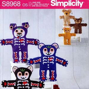 May include: Simplicity pattern featuring plush bear designs. The bears are in various colors, including purple, blue, and black, with skeleton-themed details. The pattern includes instructions for creating these unique, decorative bears.