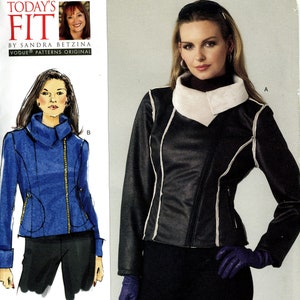 May include: A black leather jacket with a white faux fur collar and white trim. The jacket has a zipper closure and a slanted zipper pocket on the left side. The model is wearing black pants and purple gloves.