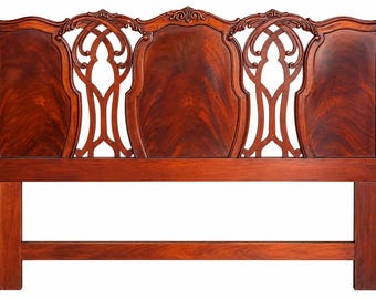 May include: A dark reddish-brown wooden headboard featuring a symmetrical design with three solid panels separated by two openwork sections. The top edge is curved with carved floral details, and the frame includes two vertical support posts.