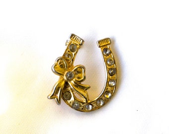 Vintage goldtone horseshoe and bow rhinestone brooch