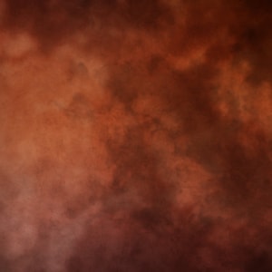 May include: A brown background with a cloudy, textured effect. The background is a dark brown color with lighter brown clouds throughout.