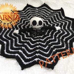 Peut inclure: Une couverture crochet&eacute;e noire et blanche avec un motif en zigzag, repr&eacute;sentant une poup&eacute;e Jack Skellington. La couverture a une forme d'&eacute;toile. Le mot "PATTERN" est visible sur l'image. Le logo Adventures in Yarnia est dans le coin sup&eacute;rieur gauche.