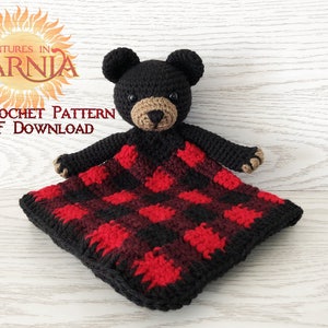 May include: A handmade crochet bear security blanket with a black head and a red and black plaid pattern on the blanket. The text "Adventures in Yarnia" and "Crochet Pattern PDF Download" are visible.