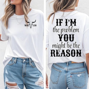 Może przedstawiać: Biała koszulka z napisem "WAL LEN" i grafiką czaszki byka z przodu. Tył koszulki zawiera czarny napis "IF I'M the problem YOU might be the REASON".