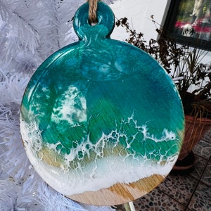 Ocean Wave Christmas tree Ornament 3.2 inches,1/8 inch thick. HandPainted resin on light birchwood. Comes with hemp twine.