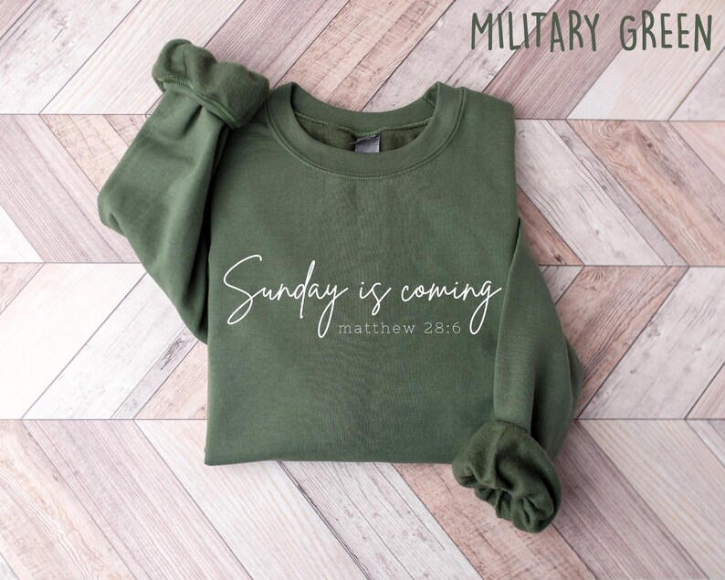 May include: A green sweatshirt with the text "Sunday is coming" and "matthew 28:6" in white lettering.