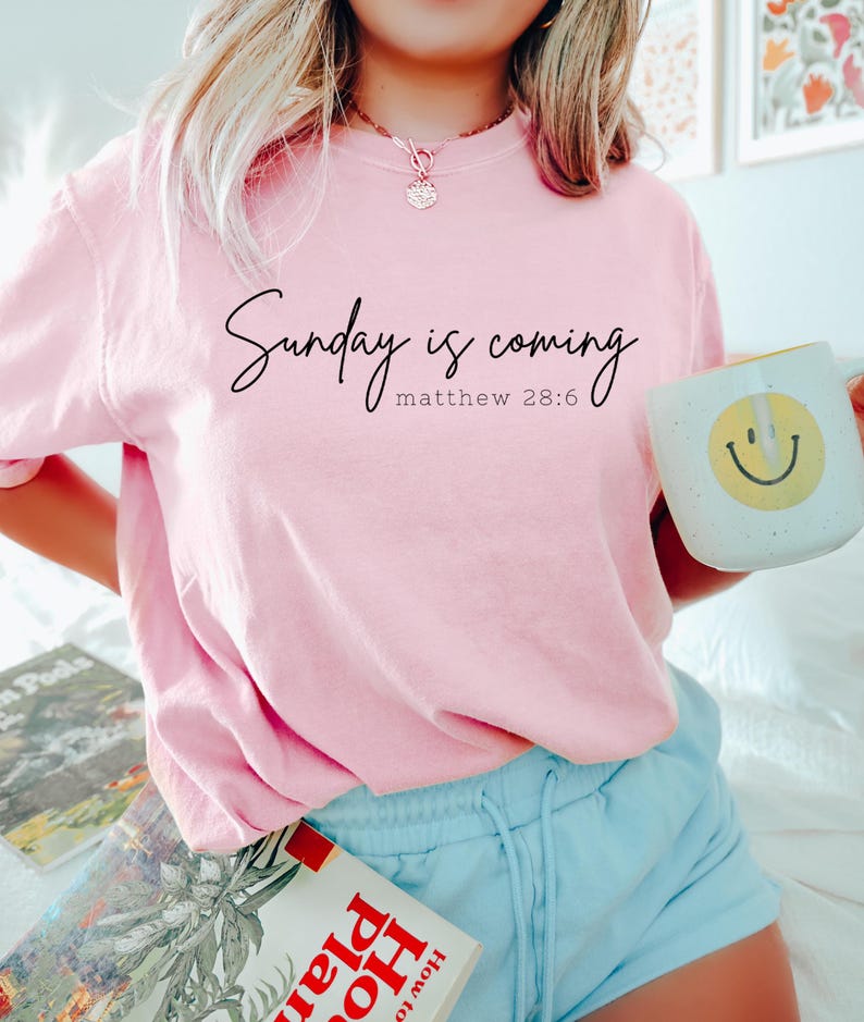 May include: A pink t-shirt with the text "Sunday is coming Matthew 28:6" printed on the front.