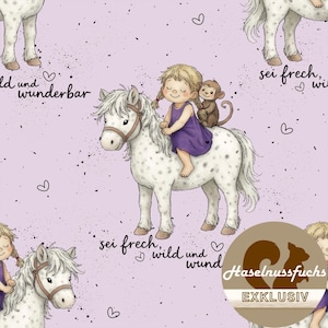 Op de afbeelding: Een herhalend patroon op een lichtpaarse achtergrond met illustraties van een meisje dat op een witte pony rijdt met een aap op zijn rug. De pony heeft bruine tuigage. De tekst "sei frech, wild und wund" staat op de afbeelding.