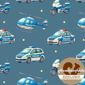 Może przedstawiać: Powtarzający się wzór niebiesko-białych pojazdów policyjnych, w tym samochodów, motocykli i helikopterów, na ciemnoniebieskim tle. Każdy pojazd ma nadruk "POLIZEI". Wzór zawiera również małe żółte kółka.