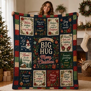 May include: A rectangular Christmas-themed quilt featuring a central panel with the text 'Sending you a big hug, Merry Christmas' surrounded by twelve smaller panels with holiday greetings, holly, ornaments, and a snowman on a dark blue background.