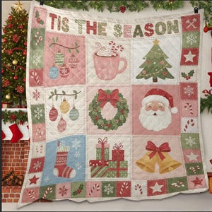 May include: A quilted Christmas blanket with a patchwork design. The squares feature festive images like ornaments, a Christmas tree, Santa Claus, and gifts. The words "TIS THE SEASON" are across the top in a decorative font. The color palette includes pink, green, and red.