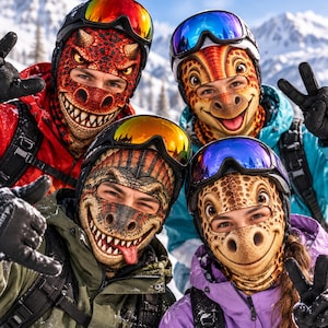 May include: Four people wearing colorful dinosaur-themed balaclavas and ski goggles. The masks feature detailed prints of various dinosaur faces with sharp teeth, scales, and expressive eyes. Each person wears a winter jacket in red, blue, green, or purple.