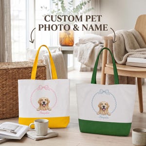 May include: Two white canvas tote bags with coloured bottoms, one yellow and one green. Each bag features a circular frame graphic with a bow at the top, containing a golden retriever illustration and the name Pumpkin printed in matching colours.