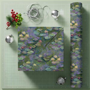 May include: Gift wrap featuring a water lily design in shades of purple, green, and yellow. A wrapped box and a roll of the same paper are displayed with silver ornaments, ribbon, and a sprig of berries.