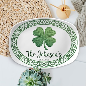 May include: White oval serving platter with a green shamrock design. The platter has a green decorative border and the text "The Johnson's EST.2026" in green. The platter is on a white surface.