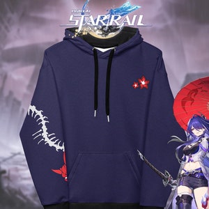 May include: A navy blue hoodie with a white design on the sleeve and a red flower design on the front. The hoodie has a black drawstring and a black lining. The text "Honkai Starrail" is visible at the top of the image.