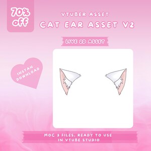 May include: A digital asset for a VTuber, featuring two stylized cat ears. The ears are white with pink inner details and a fluffy texture. The image includes text that reads "CAT EAR ASSET V2" and "LIVE 2D ASSET" on a pink background. A pink heart with "INSTAN DOWNLOAD" is also present.