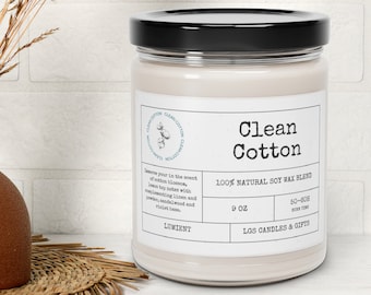 May include: A white candle jar with a black lid. The label reads "Clean Cotton 100% Natural Soy Wax Blend" and "9 oz". The candle is made by LGS Candles & Gifts.