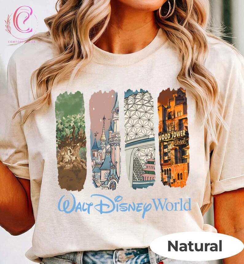 May include: A natural-colored t-shirt featuring four vertical rectangular designs with illustrations of Disney World landmarks. The words "Walt Disney World" are printed in blue script below the designs. The word "Natural" is printed in a white oval.