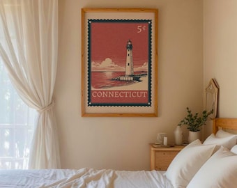 May include: A framed vintage-style print depicting a lighthouse on a shoreline, with a red and blue colour scheme. The print includes the text "CONNECTICUT" and a "5¢" stamp design. The frame is a light brown colour.