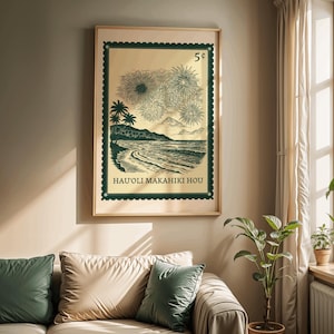 May include: A framed print featuring a vintage-style illustration of a tropical beach scene with fireworks, palm trees, and the text "HAU'OLI MAKAHIKI HOU." The artwork is set against a light beige background with a dark green border, resembling a postage stamp.