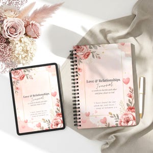 Puede incluir: Un diario y una tableta con el texto "Love & Relationships Journal" en un diseño floral. El diario es de espiral y la tableta tiene un borde negro. También hay un bolígrafo y un ramo de flores.