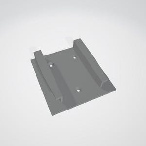 May include: A gray plastic wall mount with two slots and three screw holes.