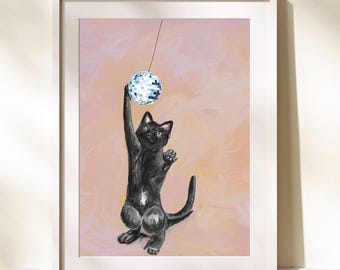 May include: A black cat reaches up to bat at a silver disco ball hanging from the ceiling against a peach-colored background.