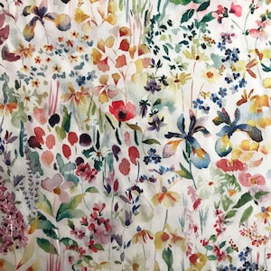 May include: A watercolor floral print fabric with a white background and a variety of colorful flowers, leaves, and stems.