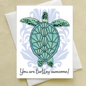 May include: A greeting card featuring a stylized sea turtle illustration with a geometric shell pattern in shades of teal and light blue. Behind the turtle is a light blue damask pattern. The text reads: You are turtley awesome!